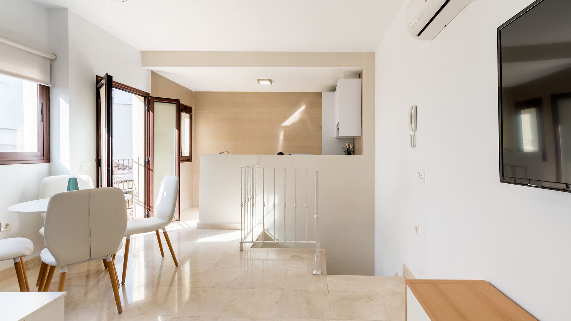 Os nossos apartamentos Sala superior de um apartamento tipo duplex, com acesso à varanda