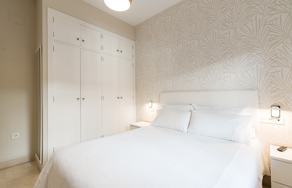 Double bedroom at Hoteles del Sur, decorated in shades of white and sand