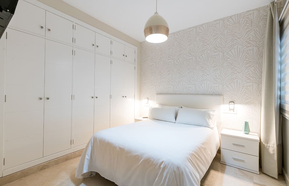 Bedroom with a double bed and a large built-in wardrobe.