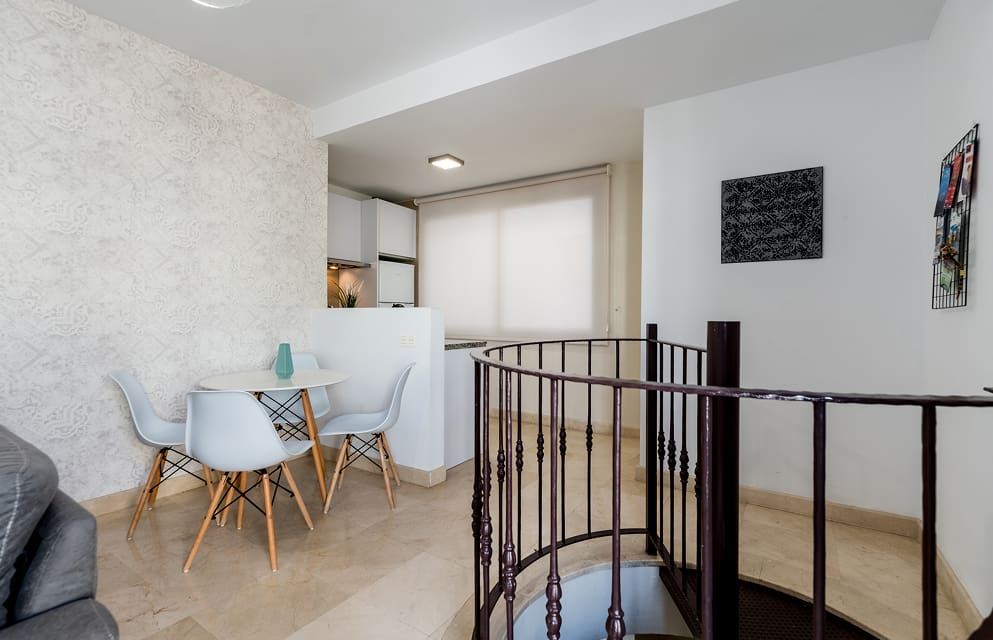 A duplex apartment with a spiral staircase connecting the two floors