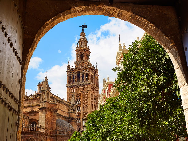 La Giralda in Seville La Giralda tower seen from one of the streets in Seville city centre